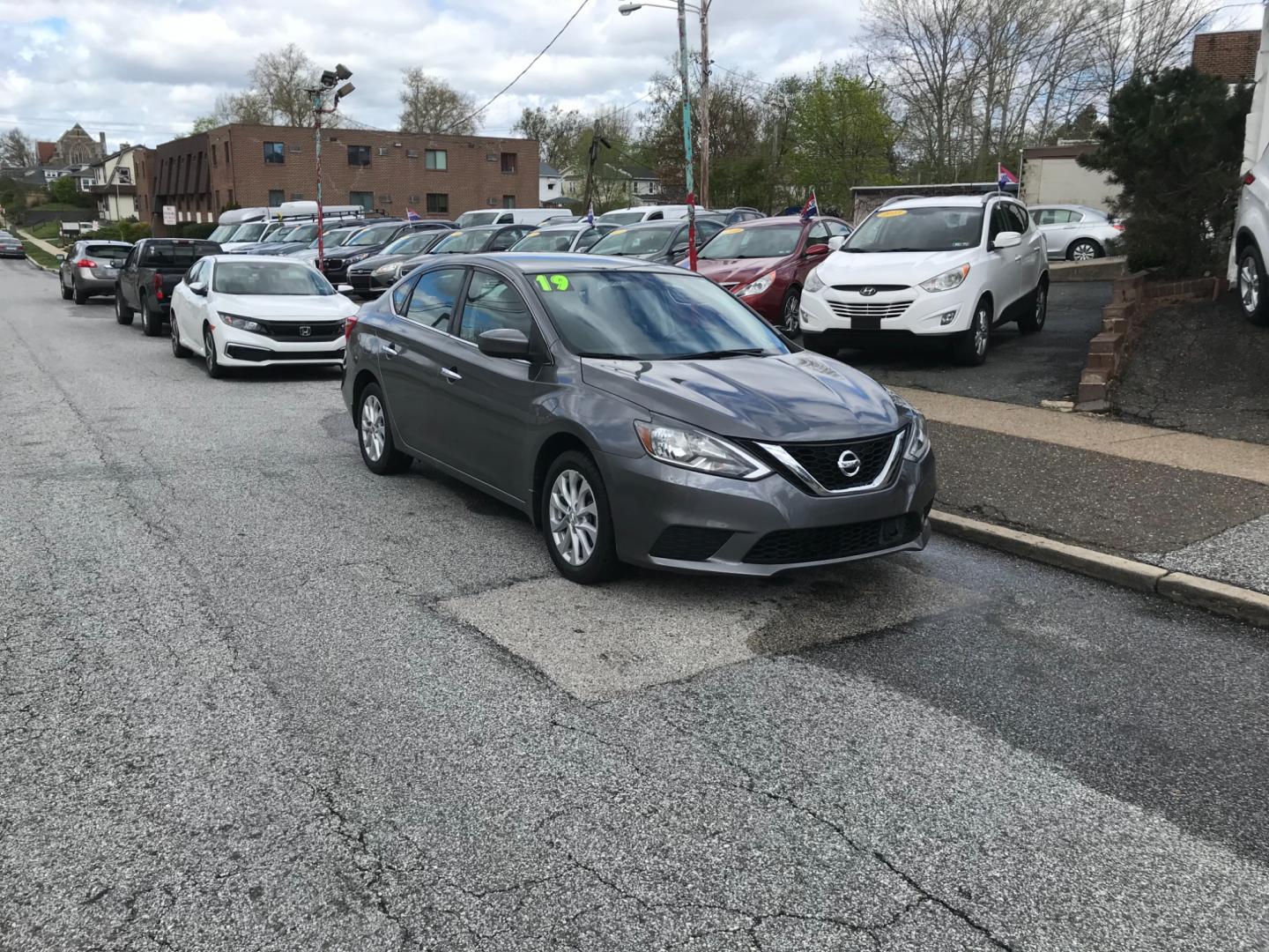 2019 Gray /Gray Nissan Sentra S (3N1AB7AP5KY) with an 1.8 V4 engine, Automatic transmission, located at 577 Chester Pike, Prospect Park, PA, 19076, (610) 237-1015, 39.886154, -75.302338 - Photo#1